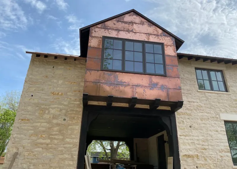 Copper metal panel facade on a stone building for Skylight Installation in Whiteland